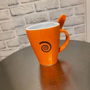 Orange heart-shaped mug with spoon